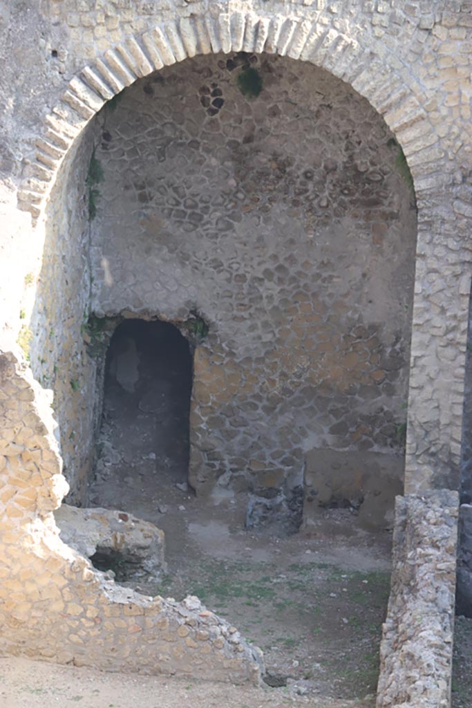 III.1/2/18/19, Herculaneum, October 2023.
Looking towards north wall of room G, with doorway into a corridor leading to a doorway onto Cardo III (blocked).
Photo courtesy of Klaus Heese.